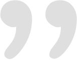 Pair of large light-gray curly quotation marks float side-by-side on a plain white background. Transcription: ” ”