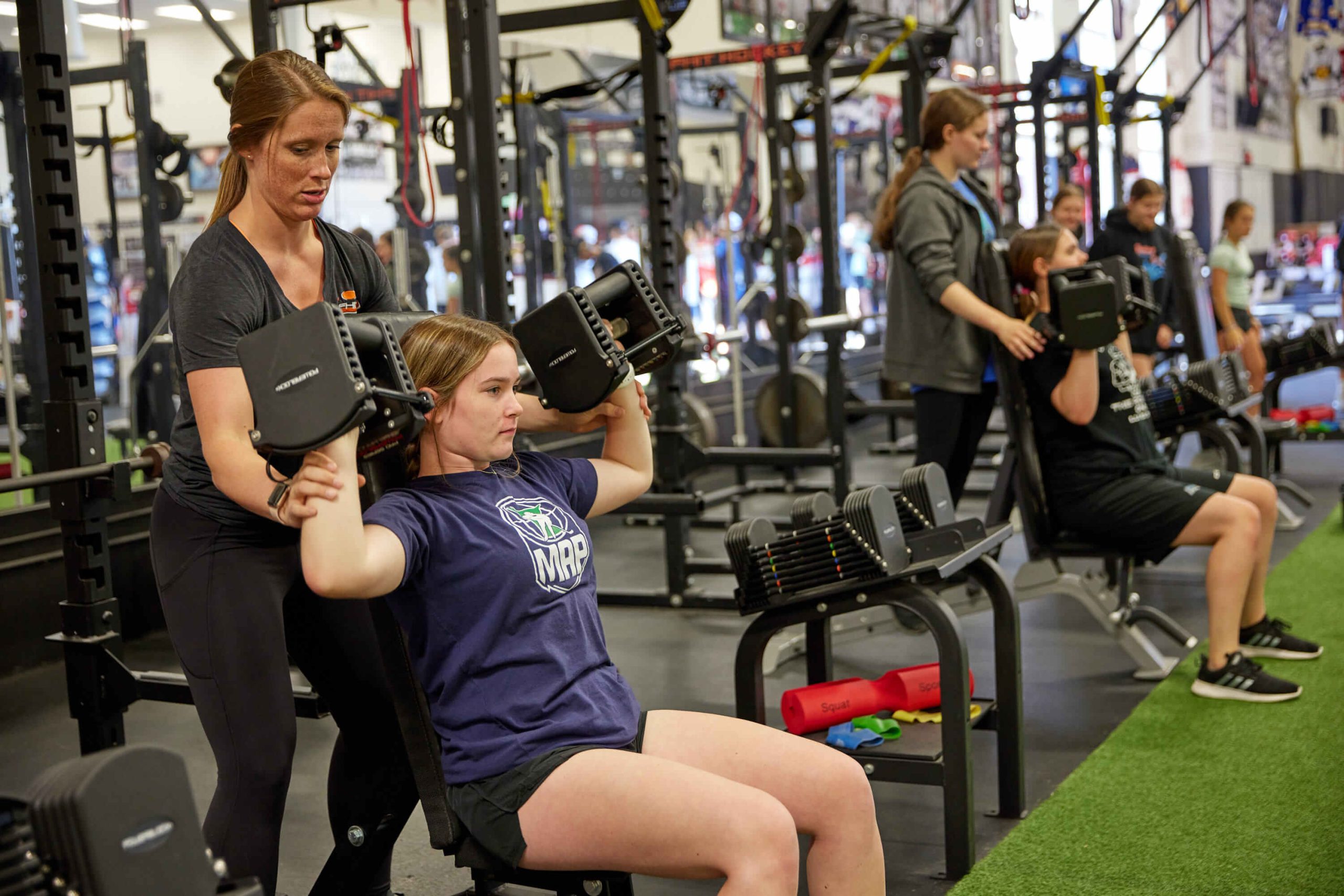 a hockey goalie doing shoulder presses for a strength exercise